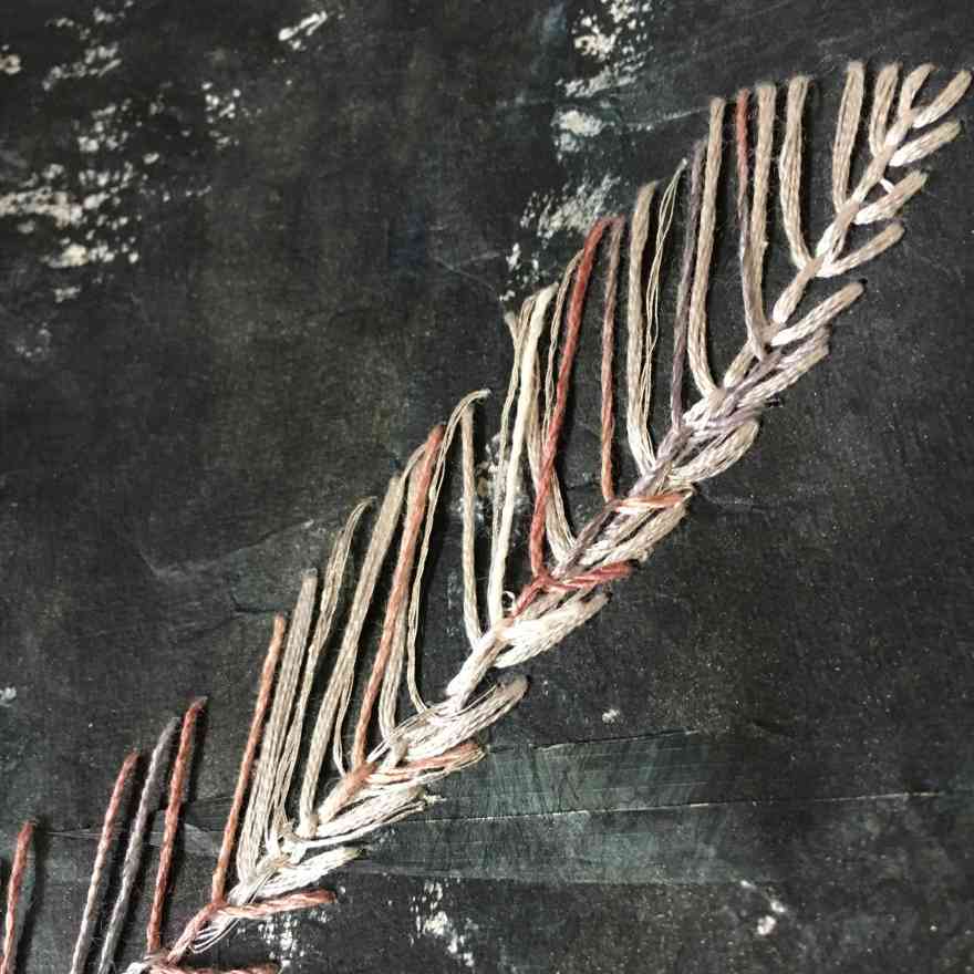 Black sand embroidery on paper